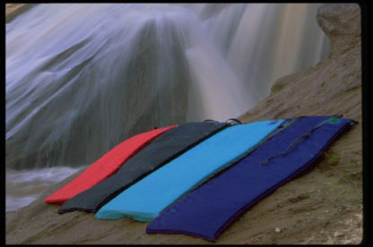 Super Pad, Guide Pad, and Full Pad water proof sleeping pads near a waterfall